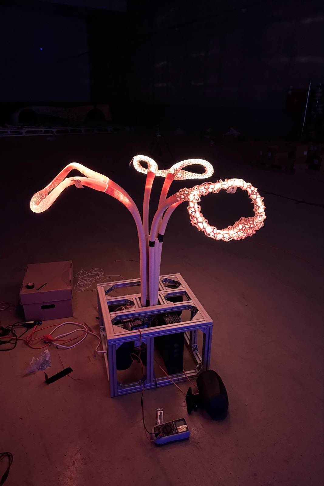 © Leo Mühlfeld Behind the scenes of physical prototype on a desk, glowing with warm light.