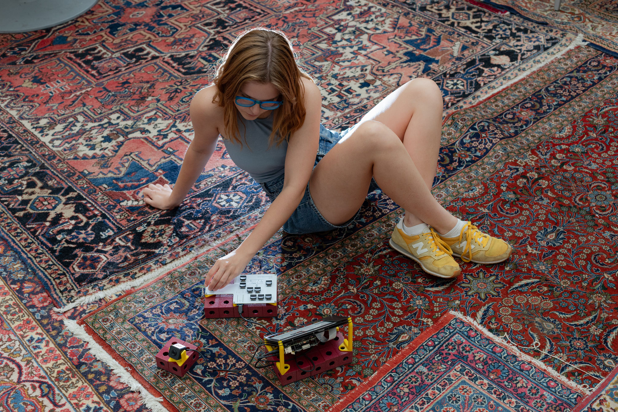 A person sitting on the carpet using the Large Language Writer