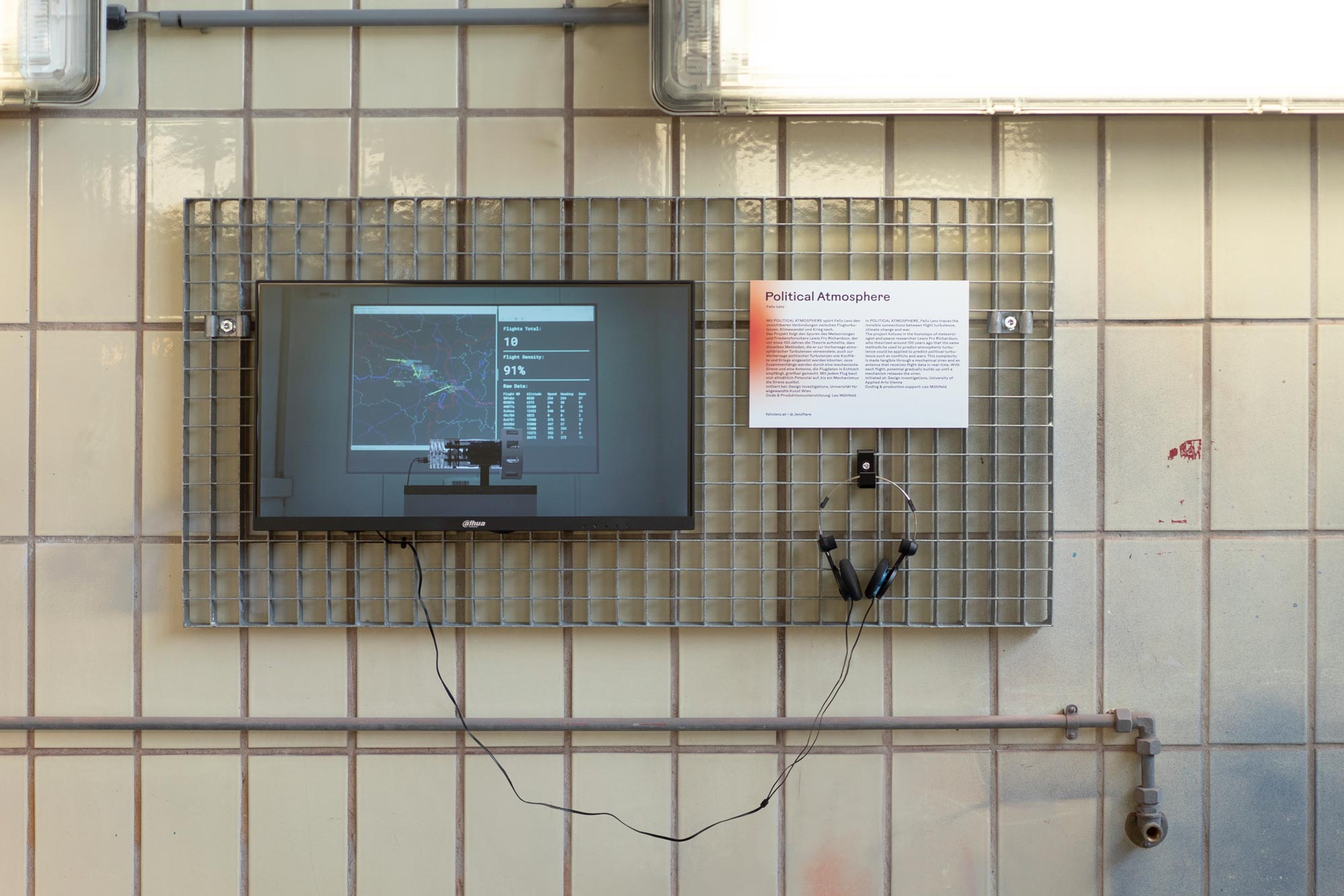 Picture of a screen and headphones mounted on a 1m by 50cm steel grid