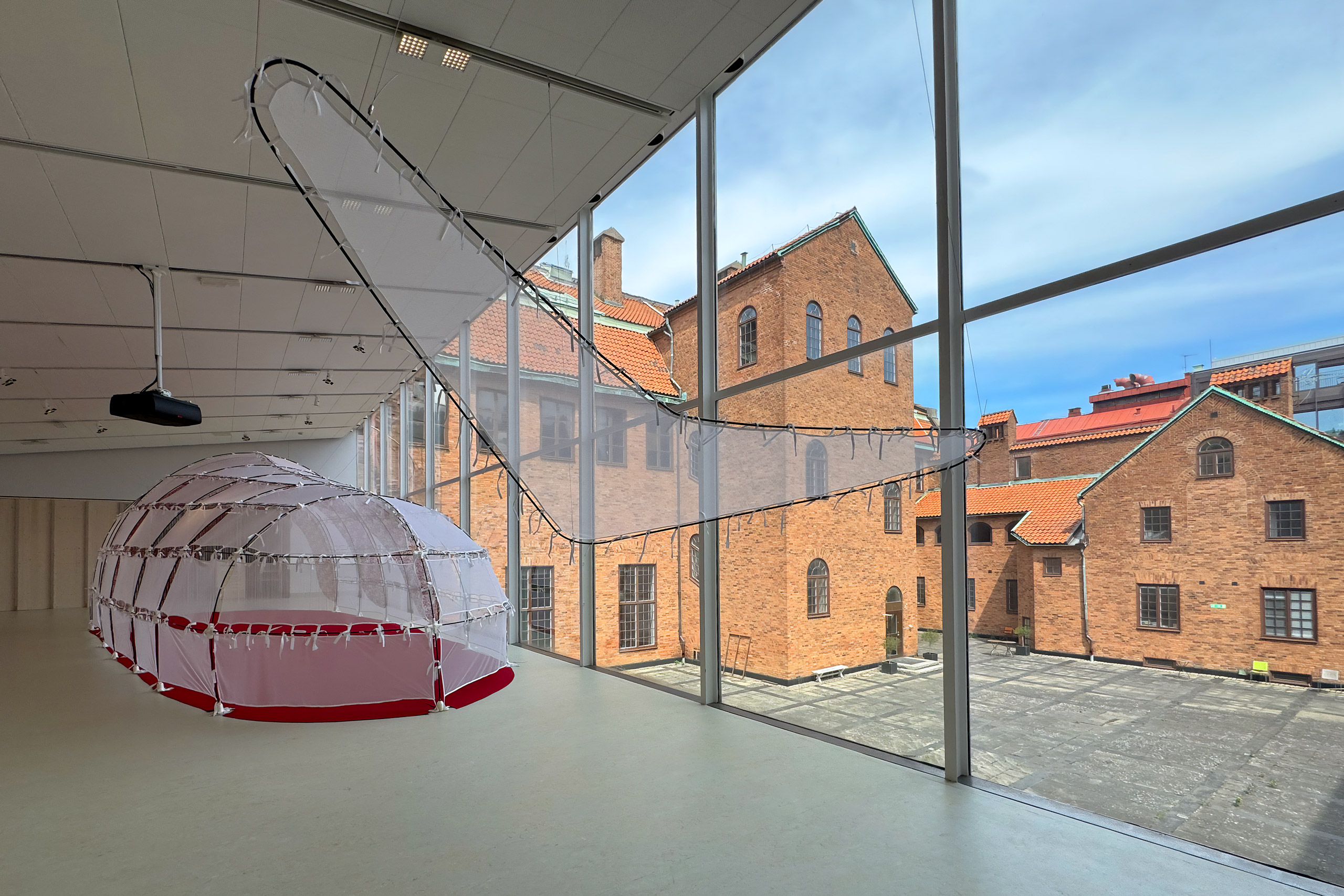 Exhibition overview showing a big whale-shaped tent-like structure at Röhsska Museum