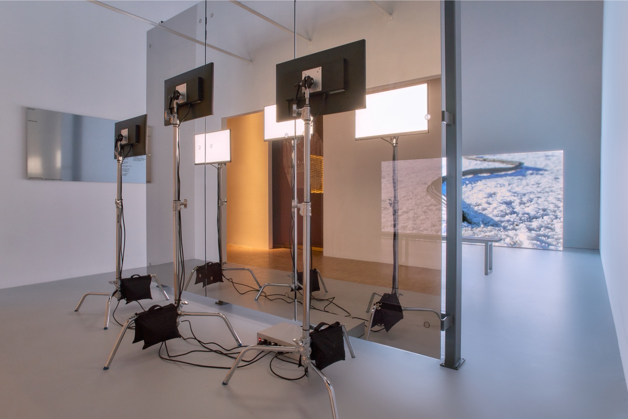 wide shot of the exhibition setup, with Projection, Wall Elements and Monitors