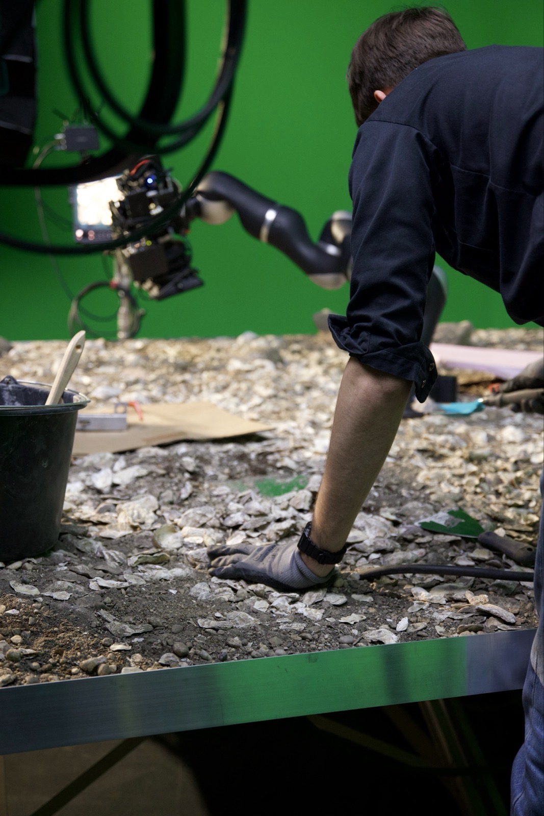 behind the scenes shot of the besoiled pedestal with the camera arm in the background