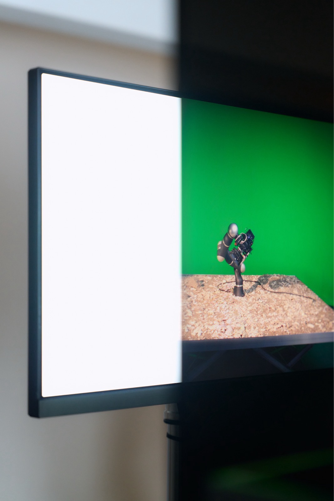 polarising screen revealing the image of the robotic arm on a screen that otherwise appears white