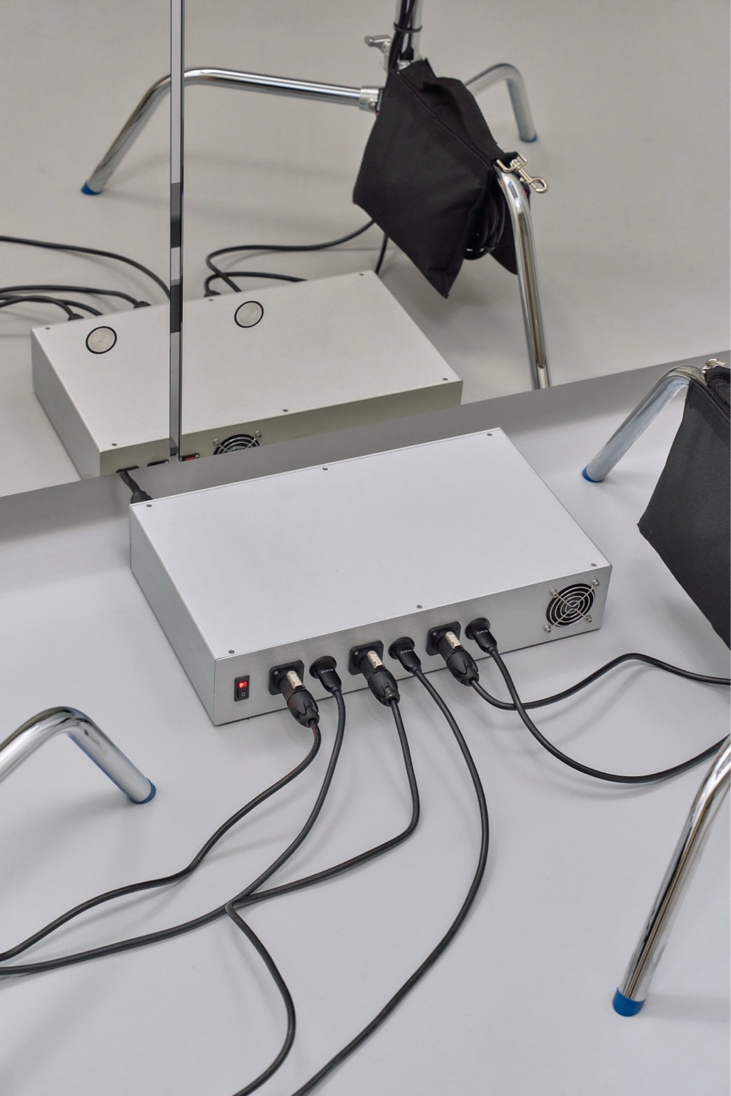 image of the media console, a uniform utilitarian-looking metal box with cables coming out