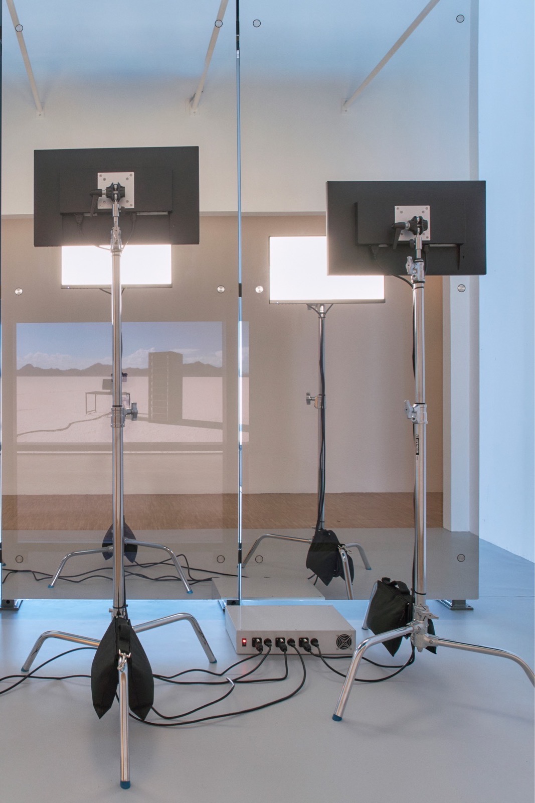 image of the wall element, translucent, showing the projection behind and the glase of two monitors