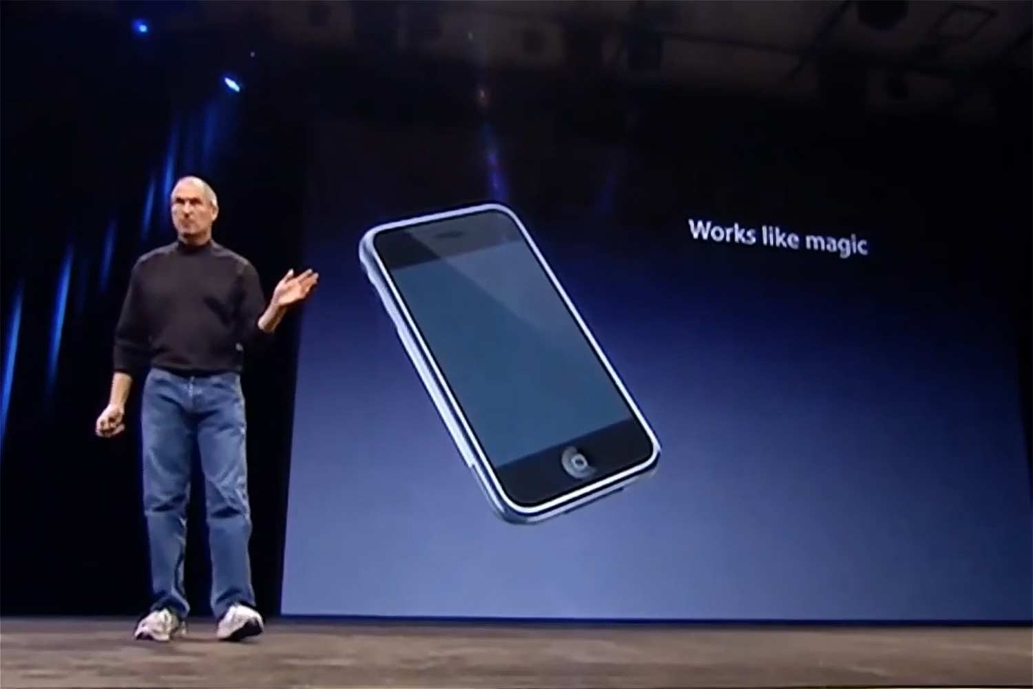 Screenshot of apple introducing the iPhone. Backdrop reads "works like magic".